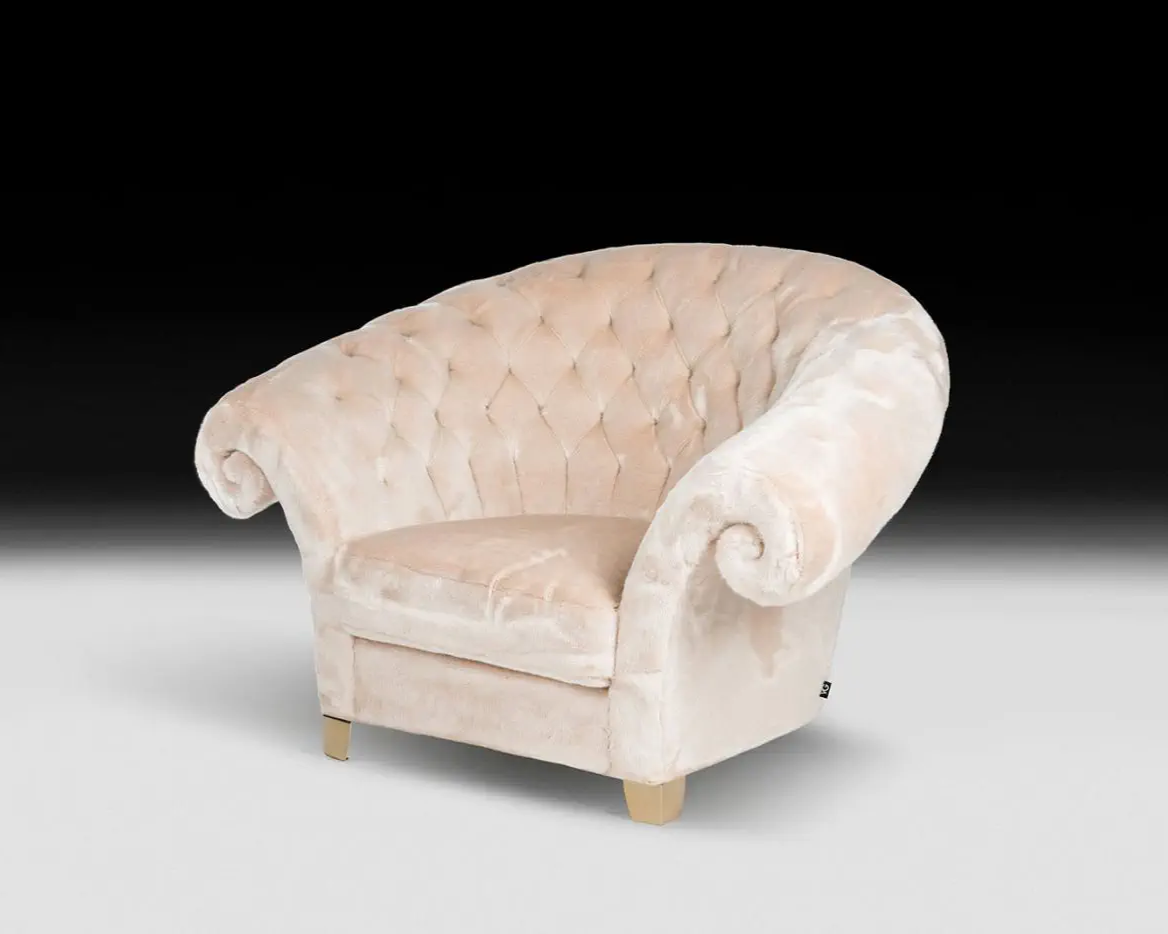 Beige armchair with tufted backrest on a white background