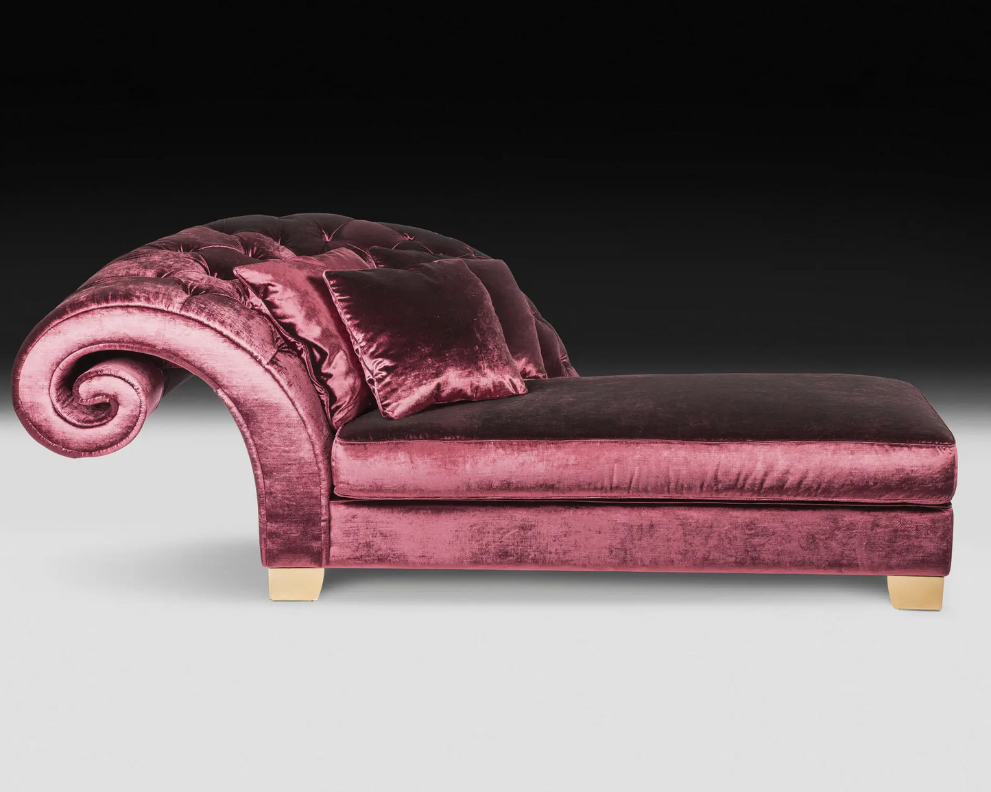 Pink velvet chaise lounge on a black background