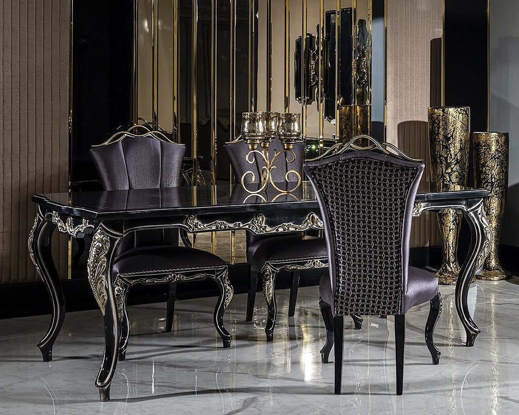 Dining room with black and gold furniture, including a table and chairs.