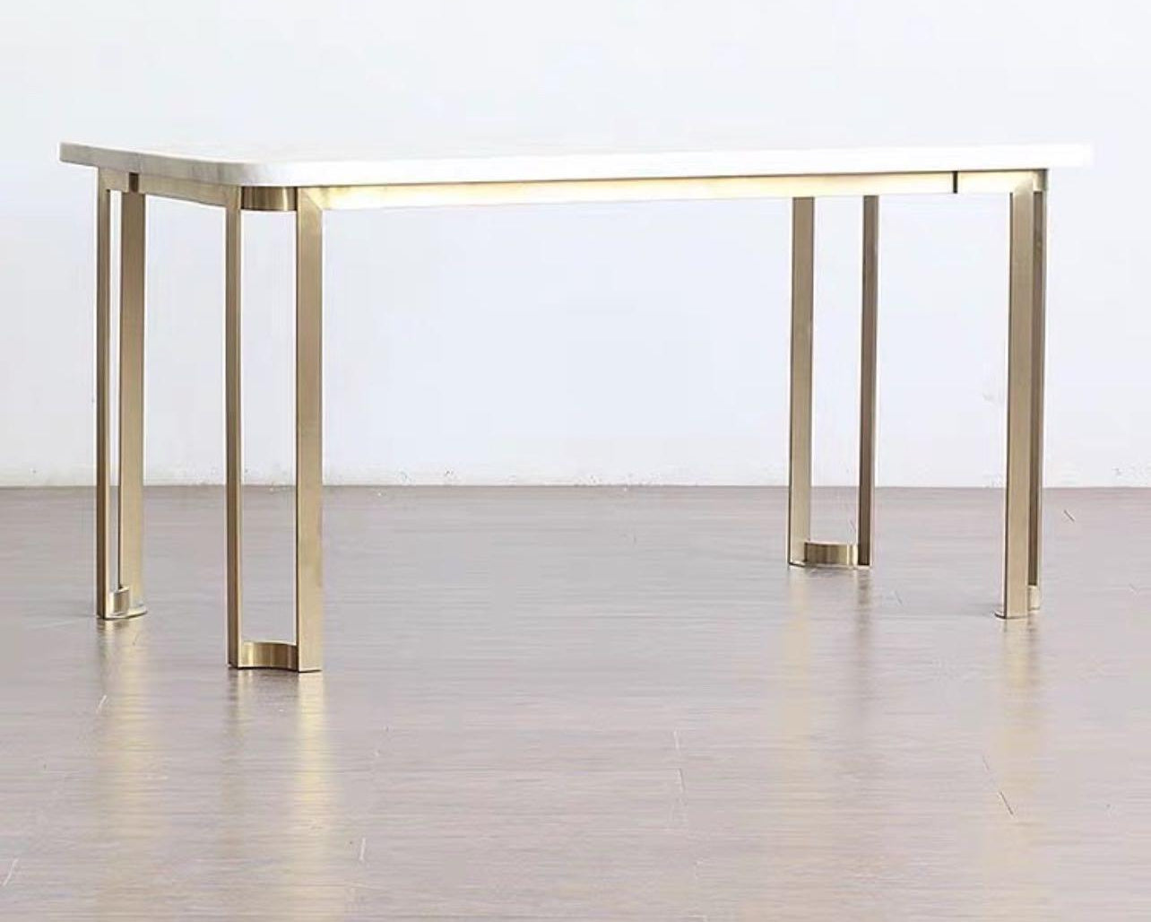 A modern luxury style dining table with a light-colored marble top and a frame made of mahogany wood, featuring a rectangular shape with metal legs.