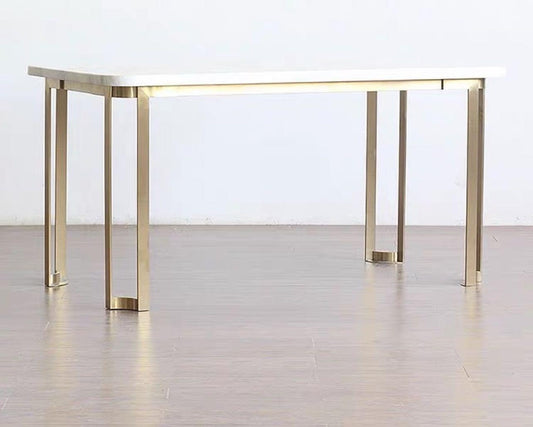 A modern luxury style dining table with a light-colored marble top and a frame made of mahogany wood, featuring a rectangular shape with metal legs.