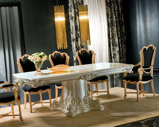 Dining room with ornate table and chairs in a stylish interior setting.
