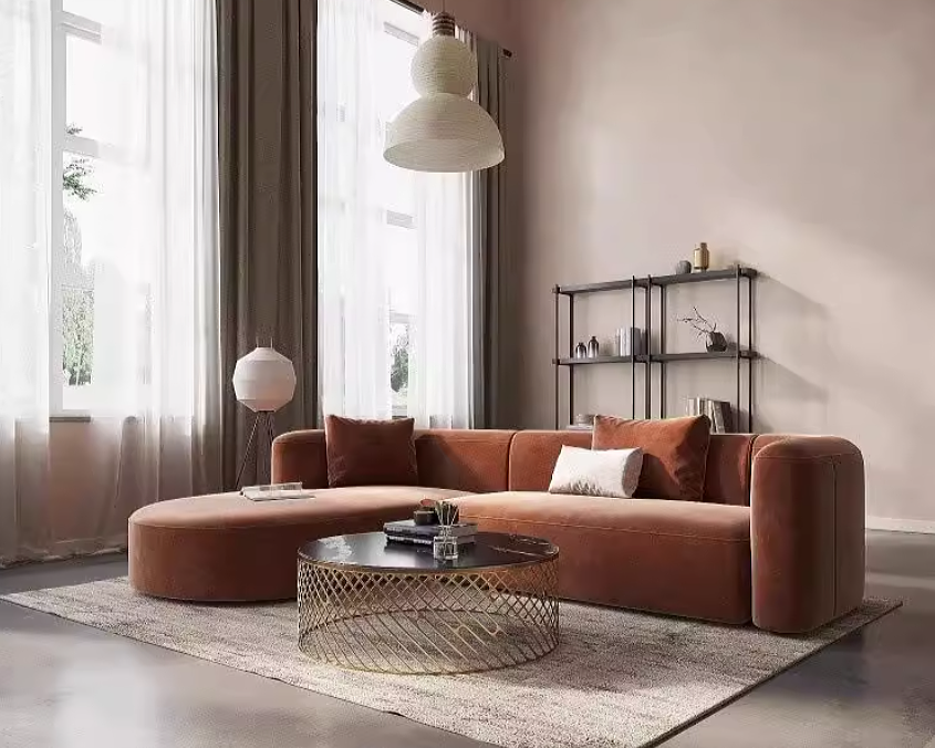 Modern living room with a neutral beige brown L-shaped sofa, coffee table, and decorative items.