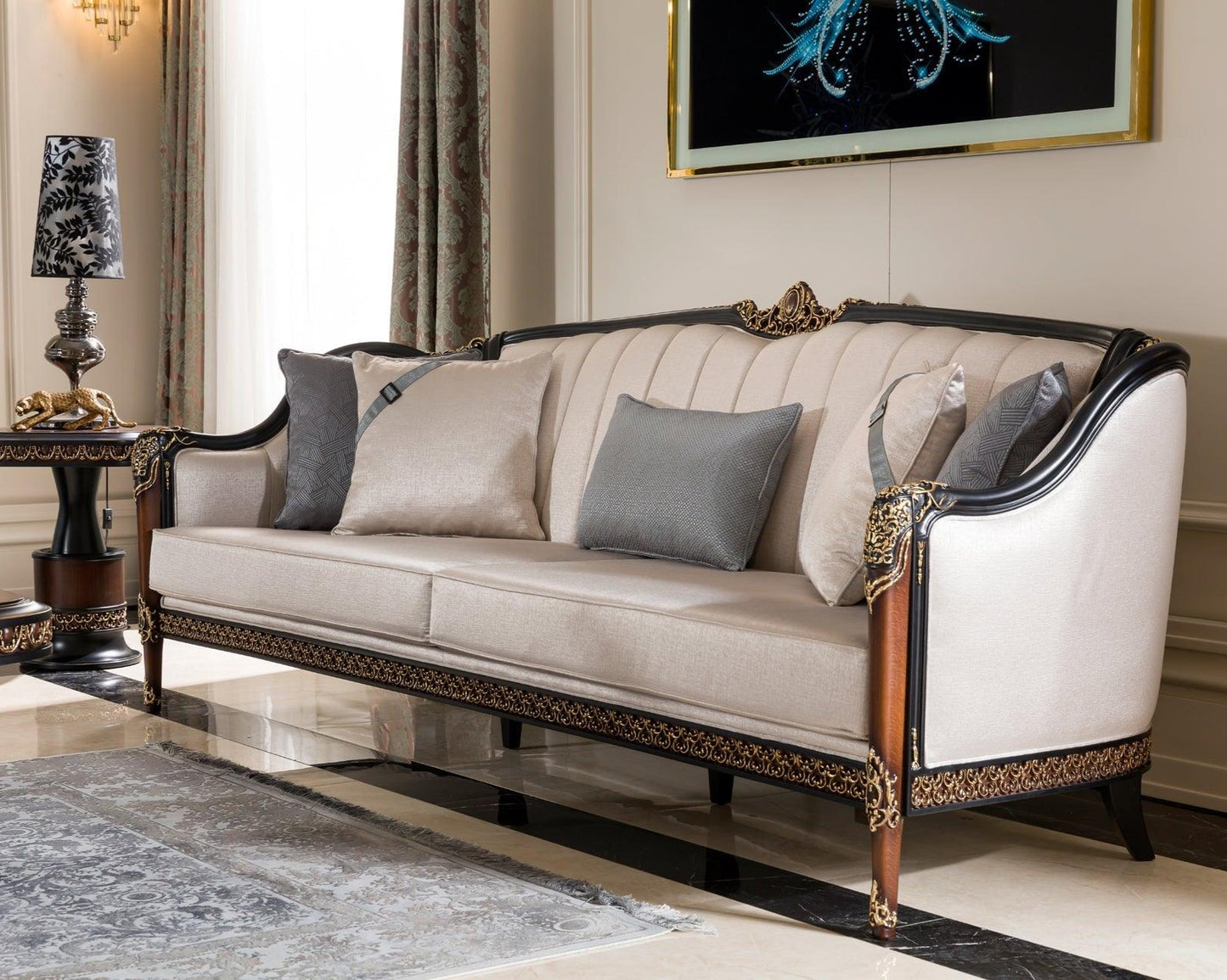 A modern French sofa with a rich walnut finish and gold accents, upholstered in alabaster white fabric, positioned in an elegant living room setting.