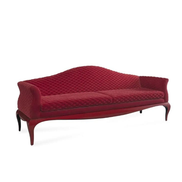 Red sofa with quilted pattern on a white background