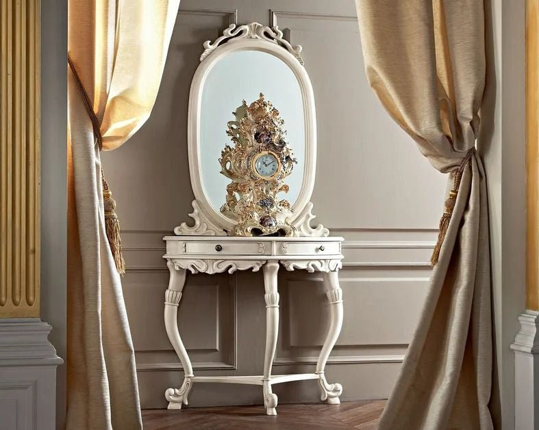 Decorative table with an ornate clock and mirror against a wall with gold accents.