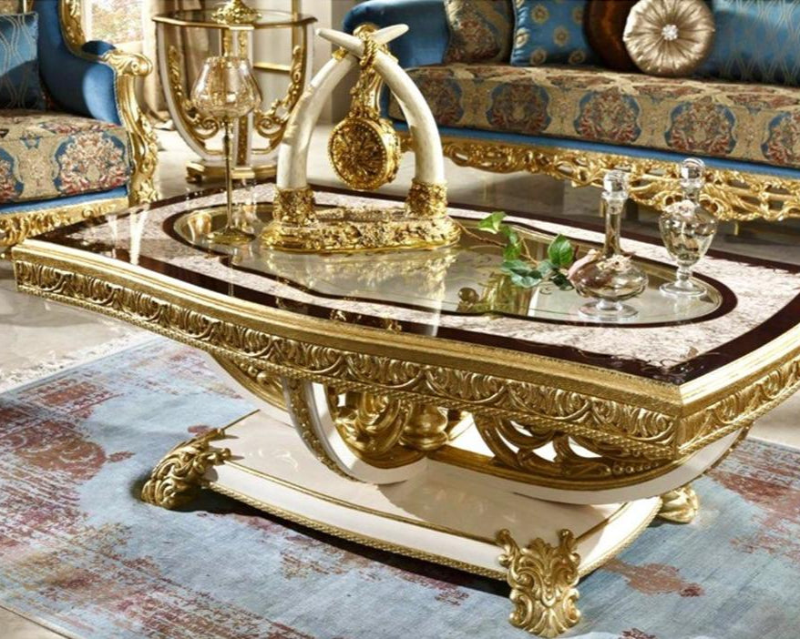 A luxurious French coffee table with carved details in a mahogany wood finish, featuring a round shape with a tufted backrest and a decorative legs, placed on a patterned rug.