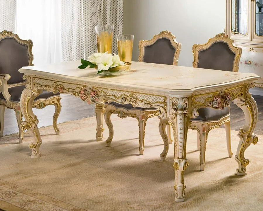 Elegant dining room with a ornate table and chairs, featuring a chandelier.