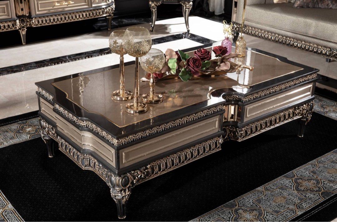 A luxurious French design coffee table made of mahogany, featuring intricate carvings and a polished finish, displayed in a lavishly decorated living room setting.