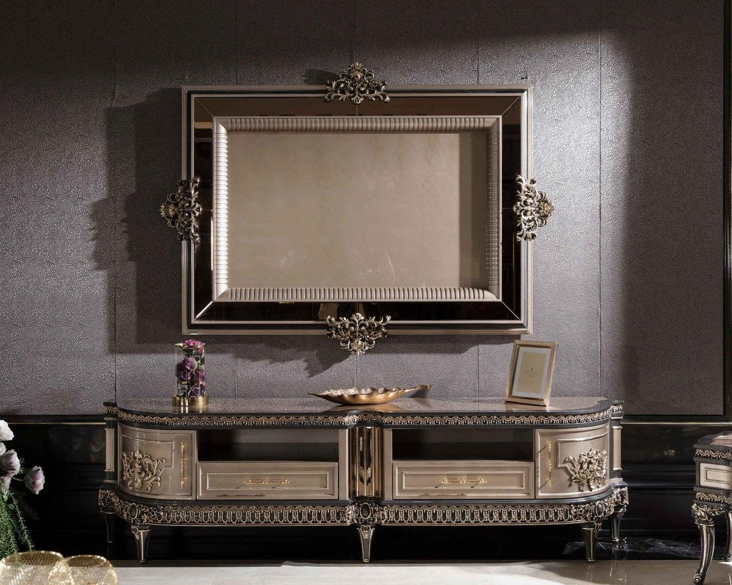 An elegant French Luxury TV console with intricate carved details in a champagne finish, displayed in a luxurious interior setting.