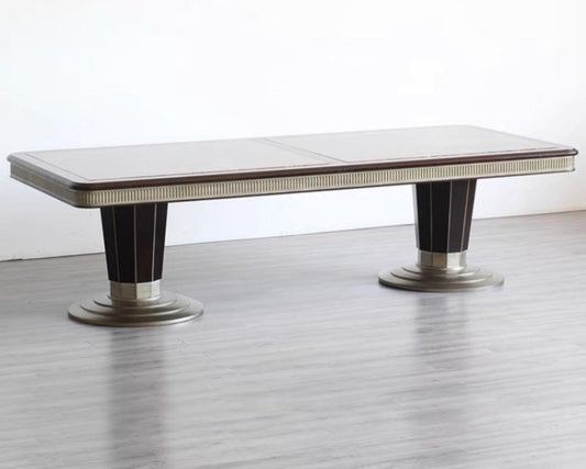 A luxury style rectangular dining table made of teak wood with a metallic frame and finish, displayed against a white background.