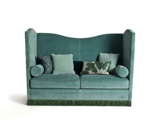 Green sofa with decorative cushions on a white background