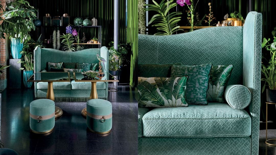 Teal sofa with decorative pillows in a stylish room with plants