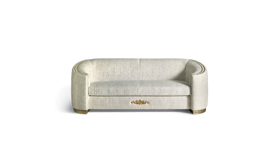 Beige sofa with a gold emblem on a white background