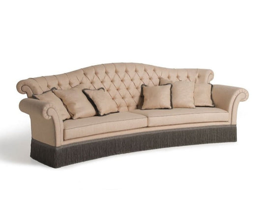 Beige tufted sofa with brown base on a white background