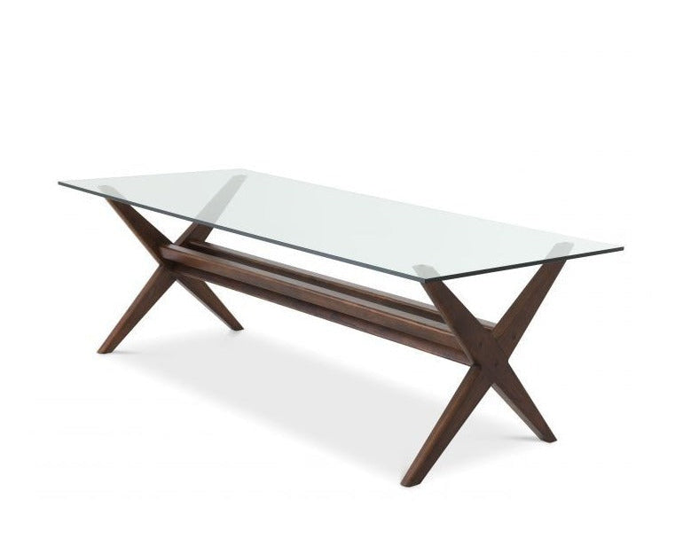 Modern dining table with glass top and wooden base on a white background