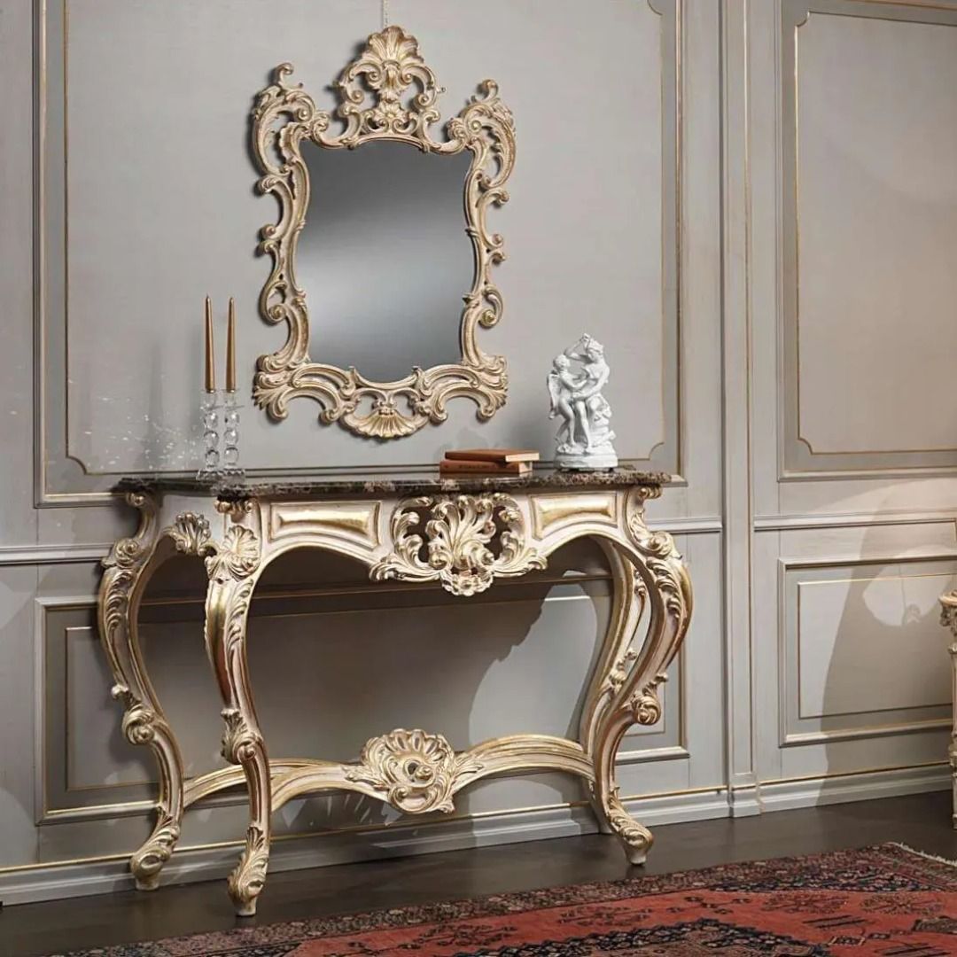 Decorative console table with ornate mirror in a room with gray walls and a red rug.