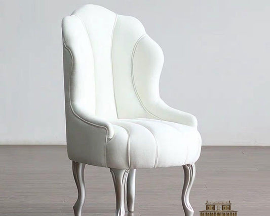 A modern luxury style white dining chair with a mahogany wood frame, featuring clean lines and simple shapes.