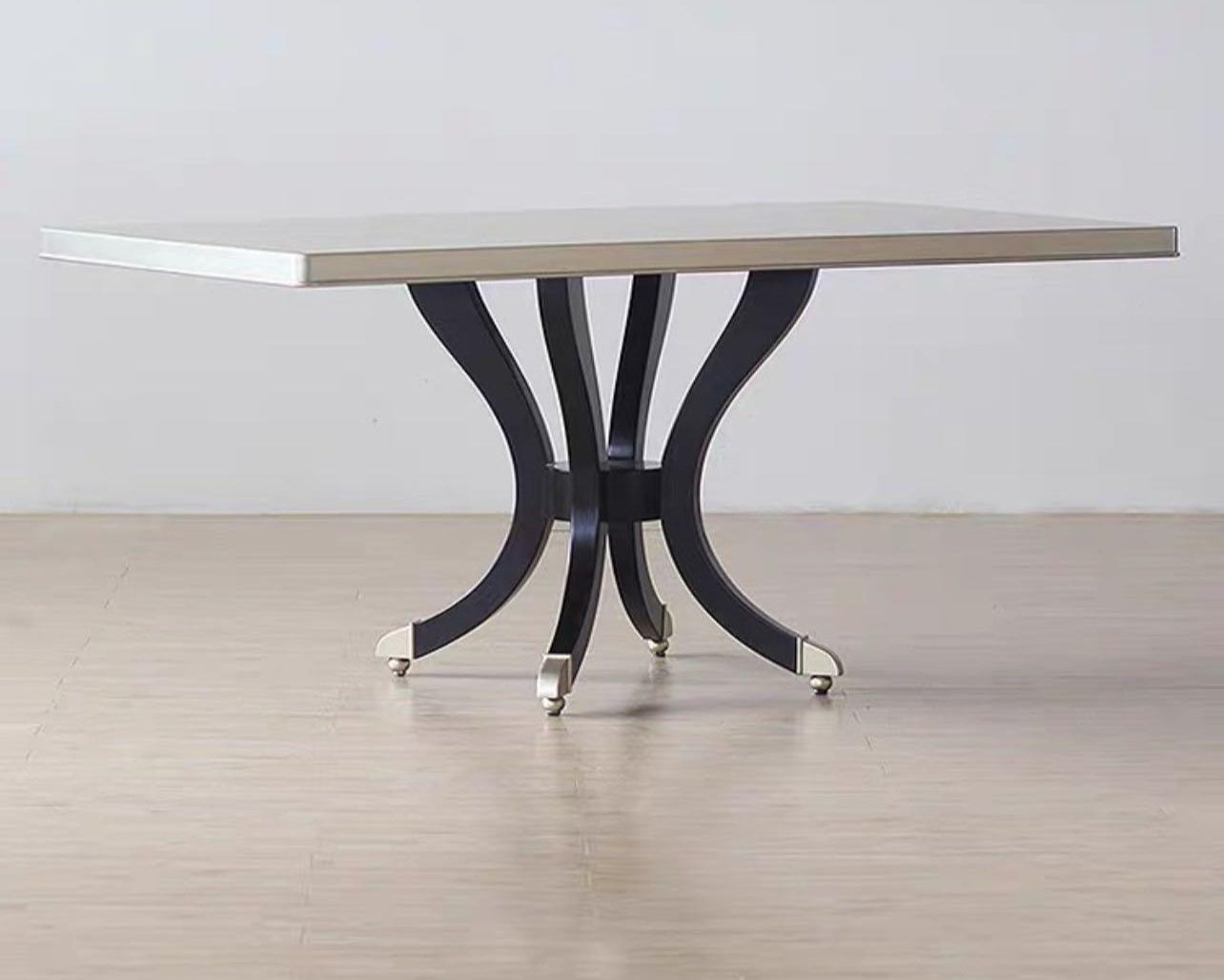 A modern luxury style rectangular dining table with a white tabletop and dark wood base with metal accents.