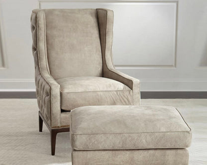 Beige armchair with matching ottoman on a neutral background