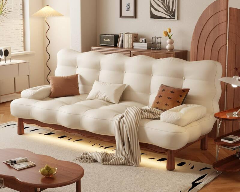 White sofa bed with wooden legs in a living room setting