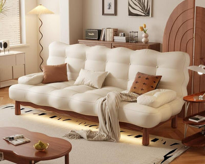 White sofa bed with wooden legs in a living room setting