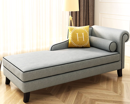 Gray chaise lounge with piping pipe lining in a living room setting.