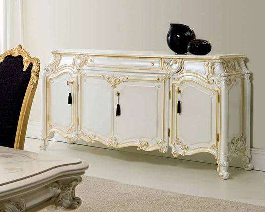 Decorative white sideboard with gold accents in a room setting.
