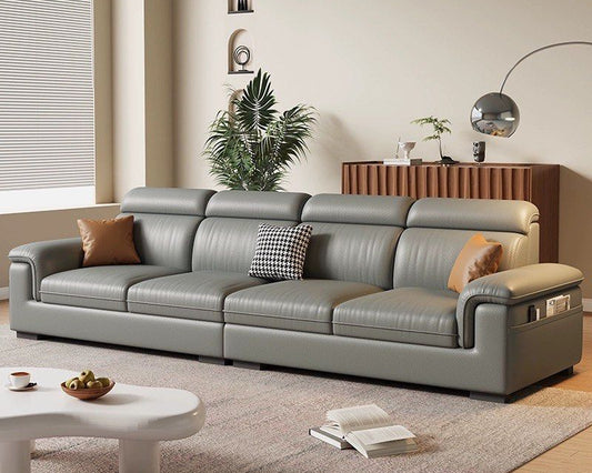 Gray sectional sofa in a living room with decorative pillows and a coffee table.