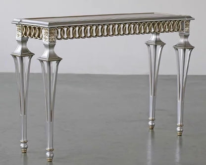 Decorative console table with intricate design on a plain background