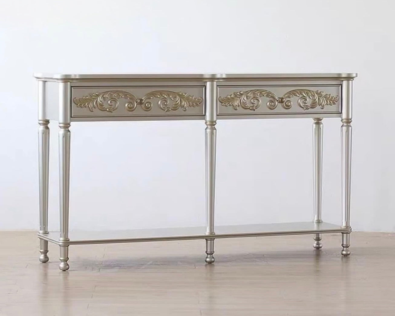 Decorative console table with ornate designs on a plain background