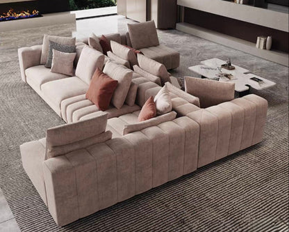 Modern living room with a large beige sectional sofa and decorative pillows.