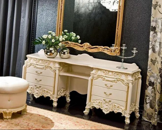Decorative white console table with gold accents in a room with dark walls and floral curtains.