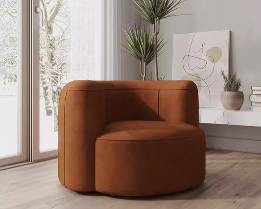 Brown armchair in a modern living room with plants and artwork.