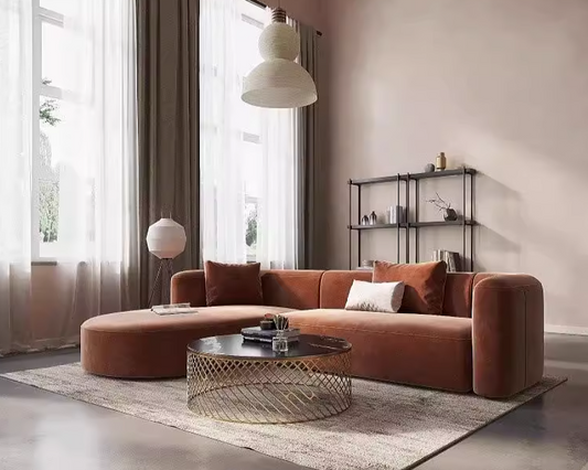 Modern living room with a neutral beige brown L-shaped sofa, coffee table, and decorative items.