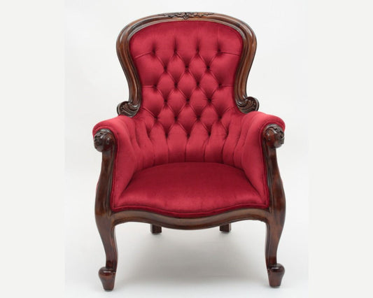 Red upholstered armchair with wooden frame on a white background