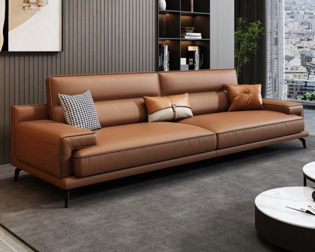 Brown leather sofa in a modern living room with decor elements.