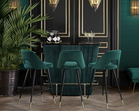 Modern contemporary bar counter table upholstered with emerald green velvet in channel tufting, with matching bar stools with backrest.
