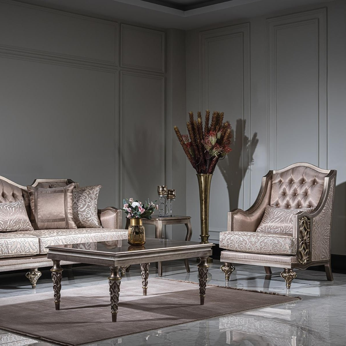 Luxury living room with ornate sofa, armchair, and coffee table.