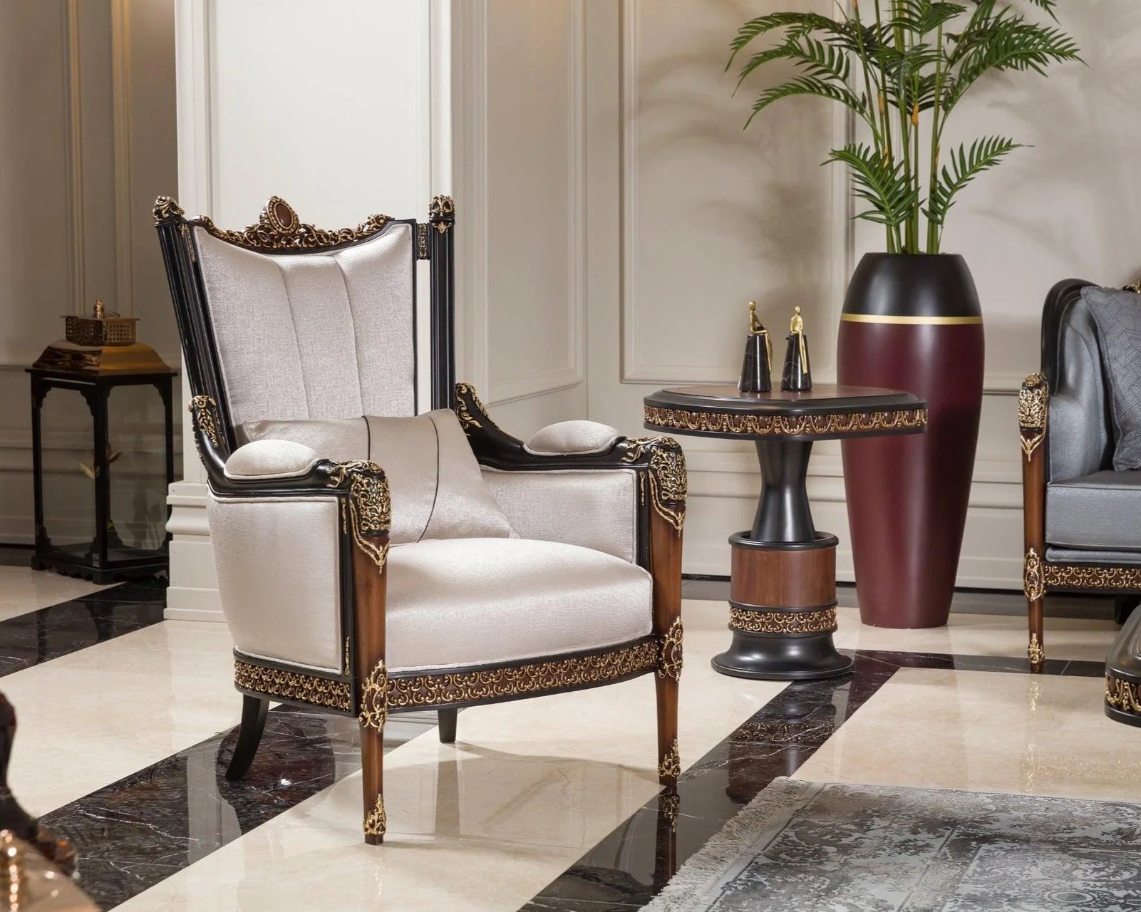 A luxurious French armchair with a walnut finish frame and gold accents, upholstered in white fabric, positioned in an elegantly decorated living room next to a brown faux fur ottoman.