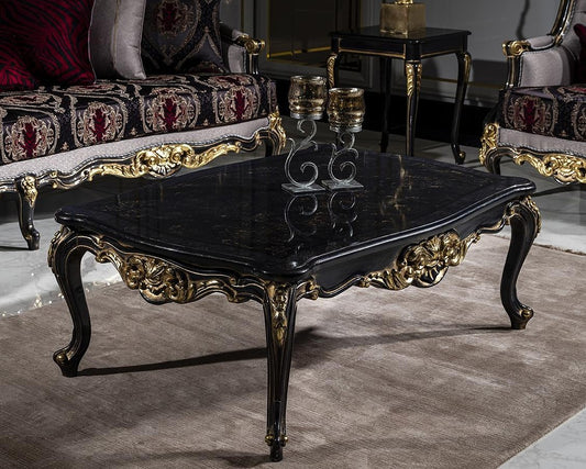 Decorative black coffee table with gold accents in a room with ornate furniture.