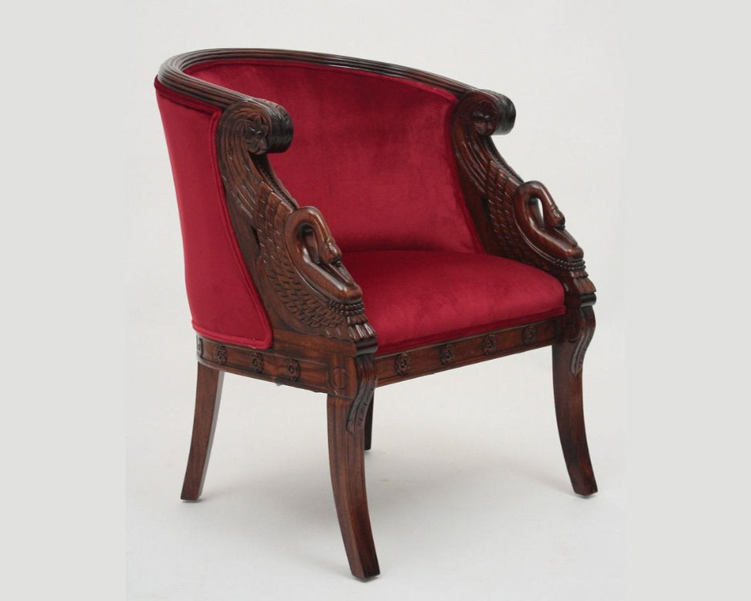 Decorative armchair with red velvet seat and wooden frame on a white background