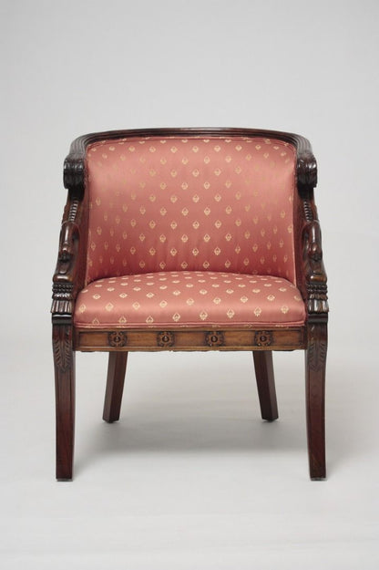 Chair with patterned pink upholstery and wooden frame on a white background
