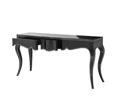 Black desk with decorative nailhead trim on a white background