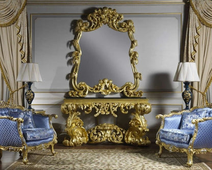 Opulent interior with ornate gold console table and blue chairs.