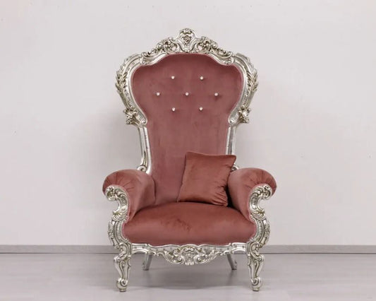 Decorative armchair with ornate silver frame and plush red cushion on a white background