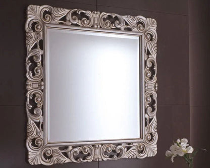 Decorative mirror with intricate frame on a brown wall