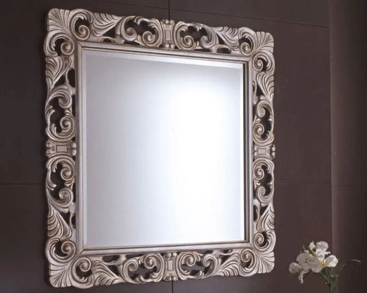 Decorative mirror with intricate frame on a brown wall
