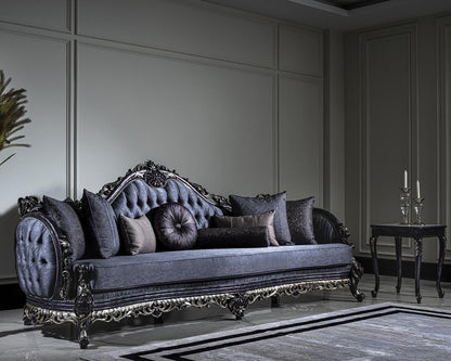 Decorative sofa with ornate detailing in a room with a candlestick holder and vase.