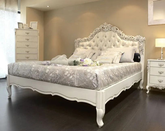 Decorative bedroom with an ornate bed and matching furniture.